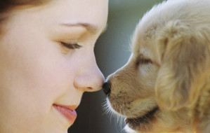 Woman Rubbing Noses with Puppy